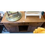 A Titchmarsh and Goodwin oak sideboard with two frieze drawers over an open display flanked by two