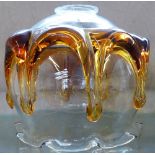 An amber and clear glass ceiling shade, the amber containing an insect
