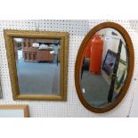 A gilt framed bevel edged wall mirror together with an oval mahogany inlaid bevel edged wall