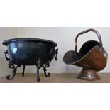 A copper coal helmet with shovel together with a twin handled oval metal coal bin on raised feet (