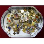 A tin of various badges