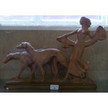 An Art Deco style plaster figure of female walking two dogs