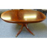 A reproduction cross-banded mahogany pedestal coffee table with splayed legs, 125cm long