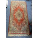 A red and blue rug, 160cm x93cm, together with another with light brown background central motif,