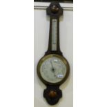 A carved oak framed aneroid barometer