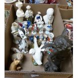 A box of various figurines including a bronzed spelter cherub