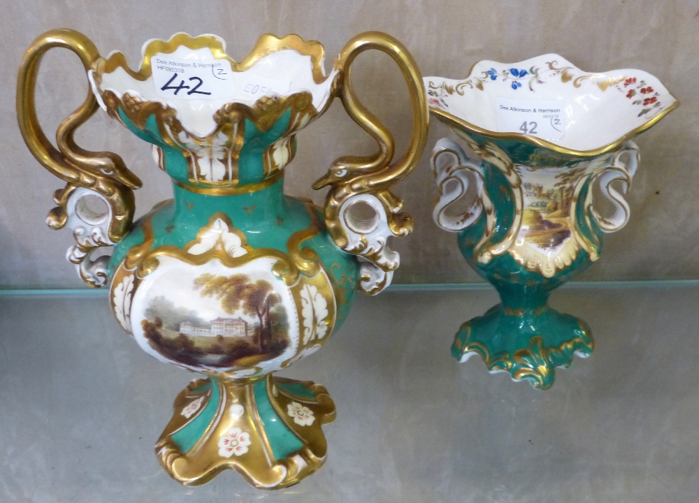 Two Victorian urn shaped twin handled vases each painted with a landscape scene (2)