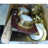 A brass cased wall clock in the form of a ships wheel, a brass table mounting cork screw, a
