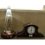 An unusual clock under conical glass dome, bearing the label Schott Duran together with a mahogany