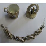A 925 silver dragon bracelet, a continental porcelain miniature cup and a figure group