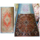 Three rugs - light brown and beige with central motif on border, 90 x 180cm, mid brown background