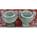 A pair of circular composition twin handled urns