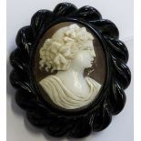 A Victorian shell cameo brooch in a Whitby jet frame