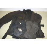 A Barbour International waxed jacket, size 46, the matching trousers, size 38, 31 inside leg, a pair