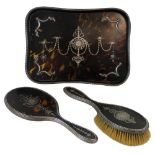 An Edwardian silver and tortoiseshell three piece dressing table set, by William Comyns, London