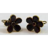 A Victorian gold mounted pair of garnet cluster ear rings, set with flat cut stones, later screw