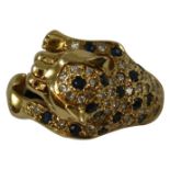 An 18ct gold sapphire and diamond Leopard ring, pave set with brilliant cut stones, size M.