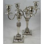 A pair of electroplated two branch, two light candelabra, the removable scrolling arms with urn
