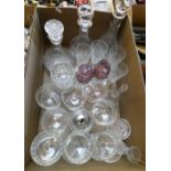 Three cut glass crystal decanters together with drinking glasses and dessert dishes