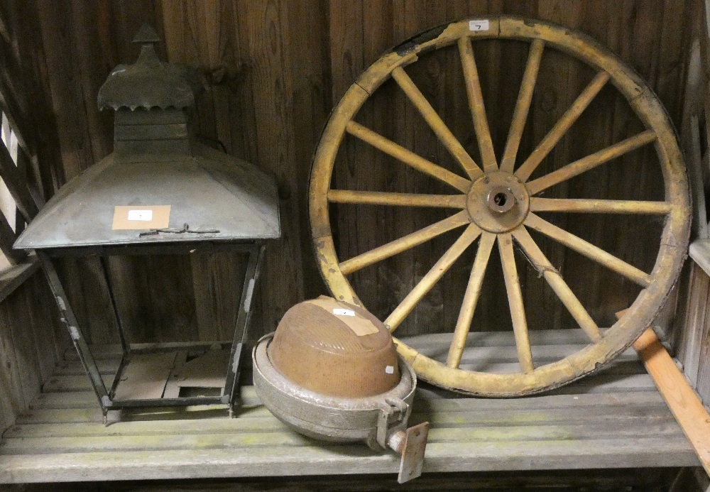 A copper lantern (lacking glass), an industrial lamp and a wooden wheel (3)