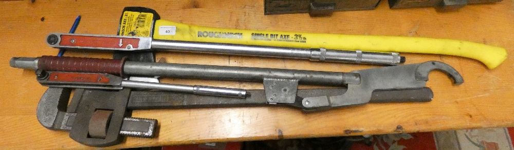 Two torque wrenches, a very large adjustable Stilson wrench and an axe