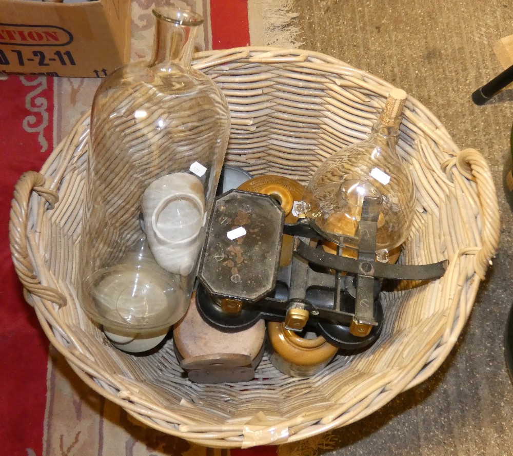 A wicker basket, various stoneware jars, glass jars and a pair of scales