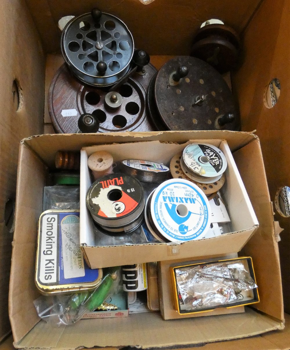 A box of fishing equipment, vintage reels, floats, etc.