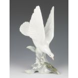 A Lladro figure of a dove sitting amongst flowers 28cmThe base is chipped