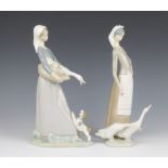 A Lladro figures of a standing girl with goose and puppy 28cm and 1 other of a standing girl with