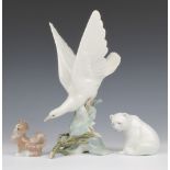 A Lladro figure of a dove 28cm, do. polar bear 8cm and do. figure of a seated dog 7.5cm (chip to