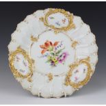 A Meissen dish with gilt decoration and panels of spring flowers 29cm There is some rubbing to the