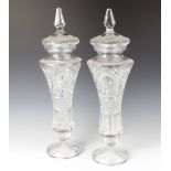 A pair of moulded glass waisted vases and covers 50cm