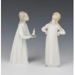 A Lladro figure of a girl in her nightdress 20cm, do. holding a chamber stick 20cm