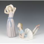 A Lladro figure of a ballerina lying down 24cm, do. of a lady wearing a sun hat 26cm
