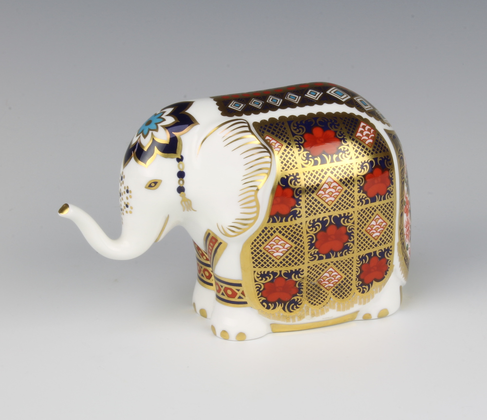 A Royal Crown Derby Imari pattern paperweight in the form of an elephant with silver stopper 9cm