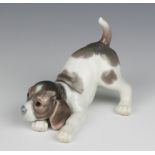 A Lladro figure of a crouching puppy 15cm