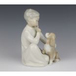 A Lladro figure of a seated child and puppy 19cm