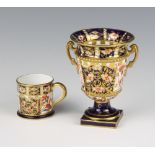 A Royal Crown Derby Imari pattern 2 handled classical urn 10cm and a do. mug 4cm