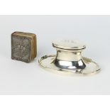 An oval silver capstan inkwell with chased monogram, Birmingham 1921, 12cm together with a silver