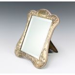 An Art Nouveau style silver photograph frame decorated with flowers and vacant cartouche 30cm