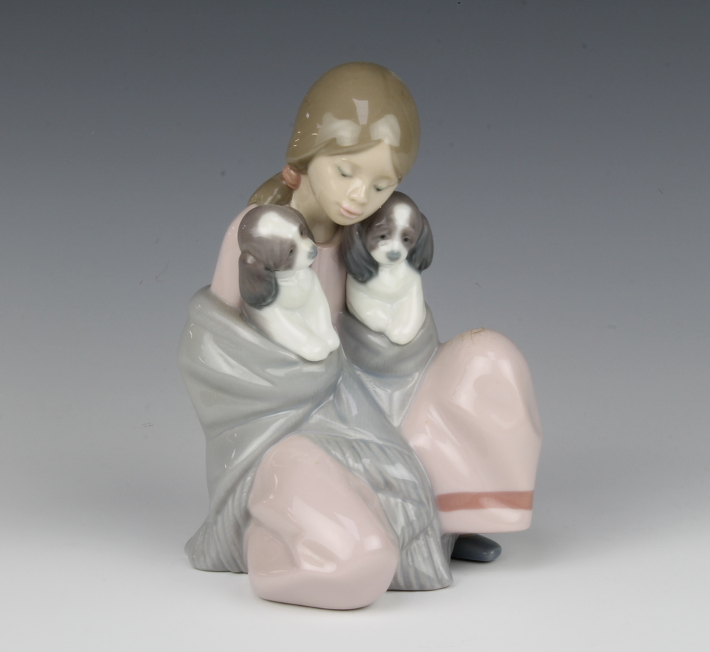 A Lladro figure of a seated girl with 2 puppies in her shawl 6226 16cm