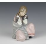 A Lladro figure of a seated girl with 2 puppies in her shawl 6226 16cm