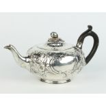 A George III silver melon shaped repousse teapot with fruit finial and floral decoration with vacant