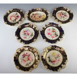 An English 19th Century porcelain dessert service with blue and gilt borders enclosing spring