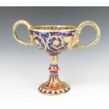 A Gualdo Tadino 2 handled lustre cup with serpent handles and masks decorated with scrolls 26cm