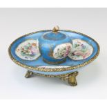 A 19th Century Sevres gilt metal mounted ink stand, the pale blue ground painted with spring flowers