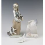 A Lladro figure of a girl holding a basket of kittens with a cat at her feet 1309 25cm together with