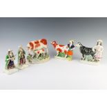 A pair of Staffordshire figures of a lady and gentleman, 2 cow creamers and a figure of a cow and