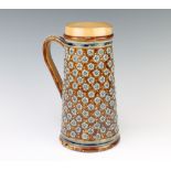 A Doulton Lambeth tapered jug with stylised floral motifs and beadwork handle 26cm