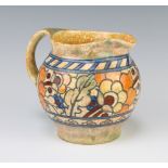 A Charlotte Rhead Crown Ducal jug the tan ground with stylised flowers and leaves 13cm